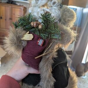 Festive Santa Figurine with Greenery and Burgundy Bag